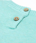 A close up of the button closure on the Frugi ava blue marl rainbow knitted children's dress.