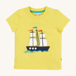 Frugi Avery Applique T-Shirt in Welly Yellow laid flat, with a Tall Ship embroidered design in the centre.