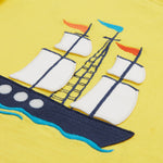 A close up of Frugi Avery Appligue T-Shirt in Welly Yellow, with a Tall Ship embroidered design in the centre.