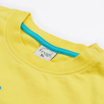 A close up of A close up of Frugi Avery Appligue T-Shirt in Welly Yellow's embroidered collar.