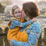 Woman carrying and kissing a little boy wearing the Babipur x Frugi organic cotton top 
