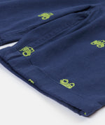 Close up of the Frugi baby short navy tractor dungarees. Showing the turn up detail and green tractor embroidery on navy organic cotton fabric.