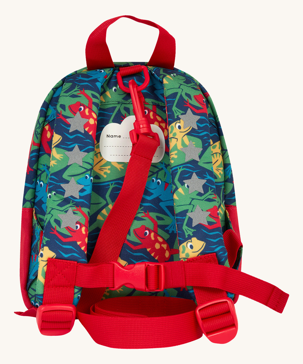 The back of the Frugi little adventures be hoppy backpack showing the reflective stars on the shoulder straps and the red rein clipped to the top of the bag