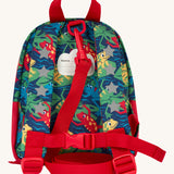 The back of the Frugi little adventures be hoppy backpack showing the reflective stars on the shoulder straps and the red rein clipped to the top of the bag