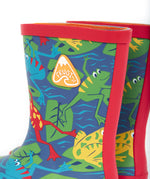 A close up of the top of the Frugi kids puddle buster wellington boots. Showing the the red trim and frog print detail on navy natural rubber material. Features a yellow triangular brand patch on the outside of the boot. 
