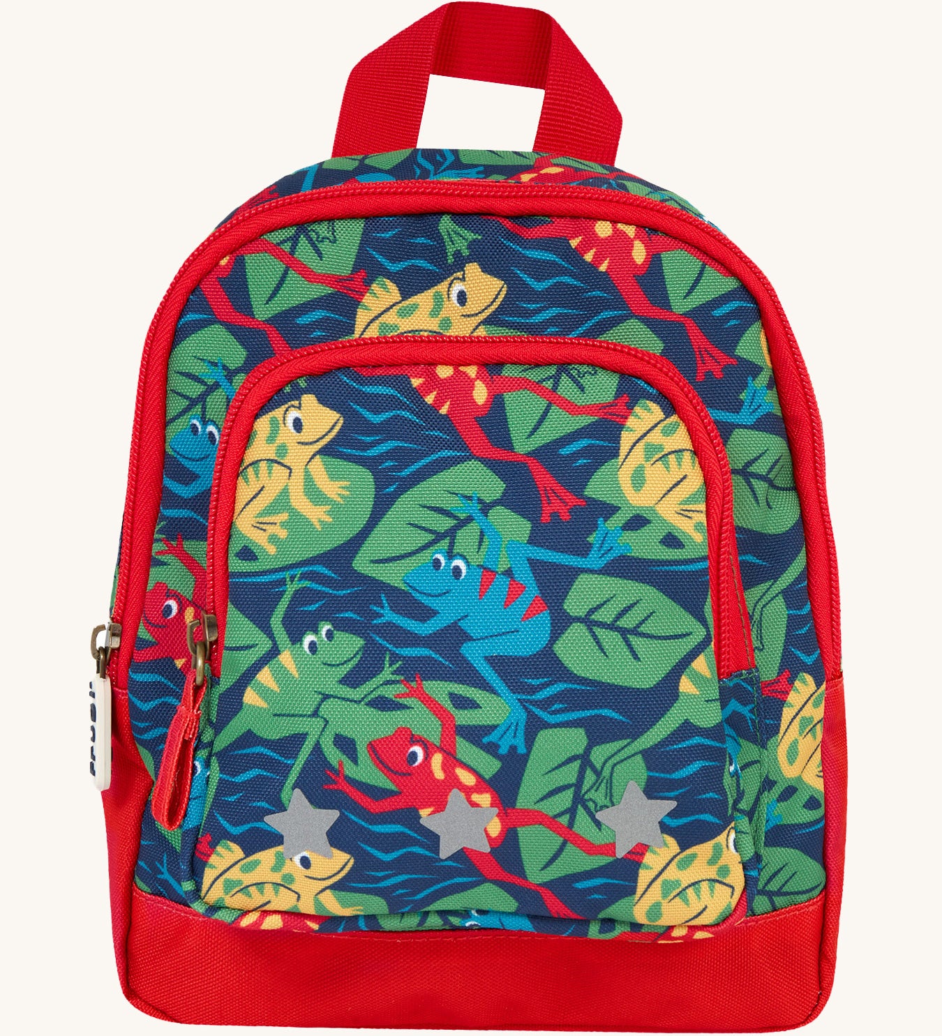 Frugi little adventures backpack in be hoppy. A small navy backpack with red trim and multiple prints of playful frogs. Features 2 compartments and reflective stars