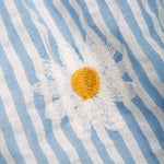 Close up of an embroidered daisy detail on the Frugi Beach Hut Blue and white Stripe Cassie Collared Dress