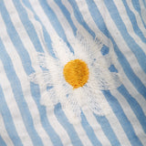 Close up of an embroidered daisy detail on the Frugi Beach Hut Blue and white Stripe Cassie Collared Dress