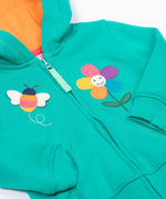 A close up of the Frugi kids carbis hoodie in dragon/bee showing the bee and flower applique detail next to the full length zip