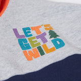 A close up of the Frugi kids ben colour block hopscotch/fun hoodie showing the lets get wild slogan near the shoulder on organic cotton fabric.