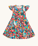Frugi Morwenna Skater Dress in the Birds Of Paradise print, laid flat. Featuring different exotic birds surrounded by colourful flowers and leaves on a pink background.