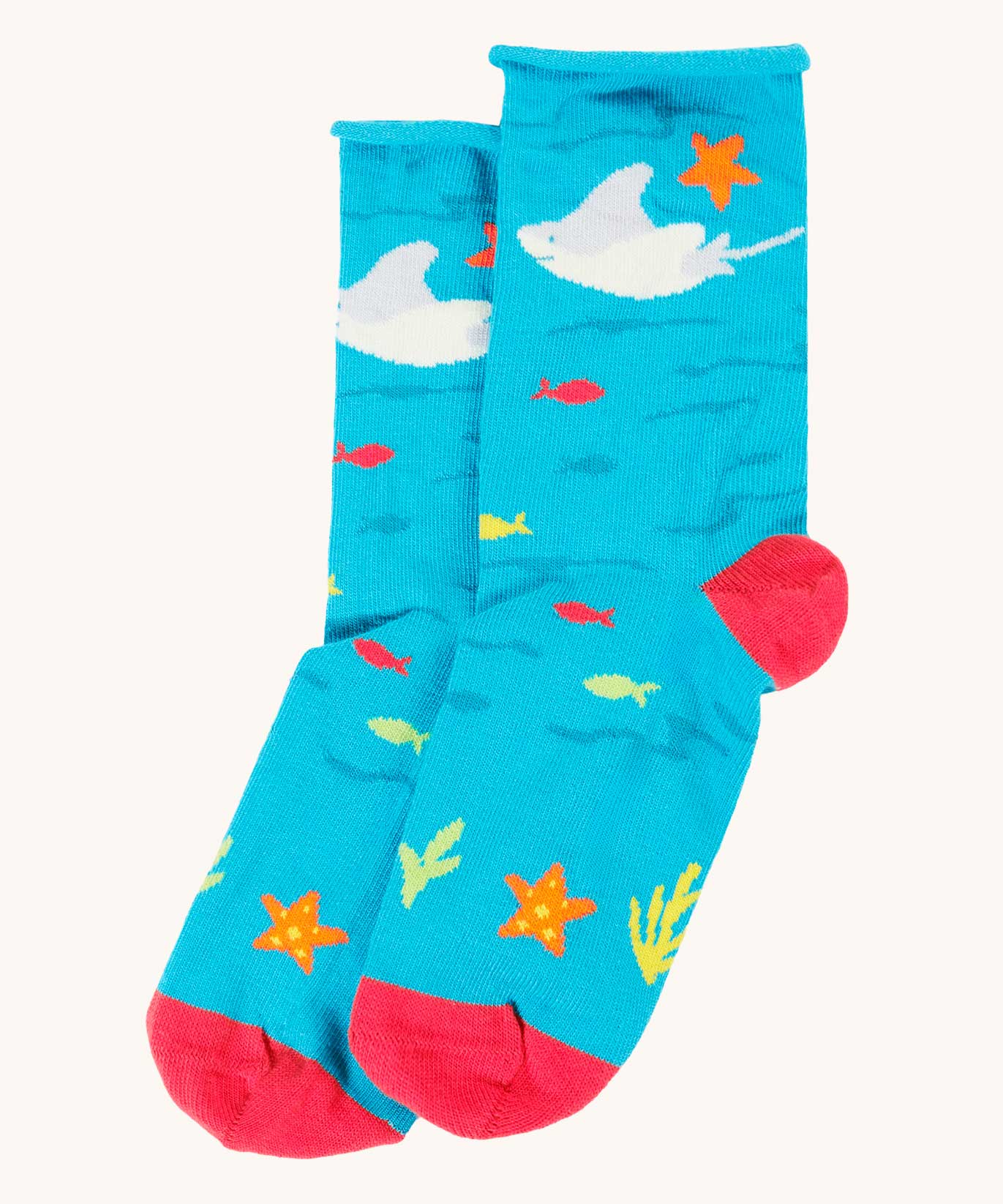 The blue sting ray socks from the Frugi pack of three sealife themed bamboo children's socks with roll tops. A blue under the ocean themed sock with sting ray, starfish, fish and coral pink coloured heel and toe caps. 