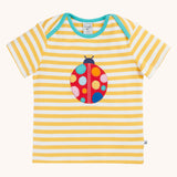 Frugi yellow striped short sleeve t-shirt with ladybird applique on the front. The ladybird has rainbow coloured dots.