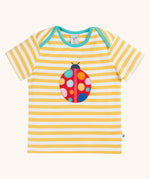 Frugi yellow striped short sleeve t-shirt with ladybird applique on the front. The ladybird has rainbow coloured dots.