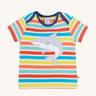 Frugi Bobster Applique T-Shirt in a Sea Rainbow Stripe print laid flat, featuring an embroidered Shark in the centre, and popper fastenings at the top.