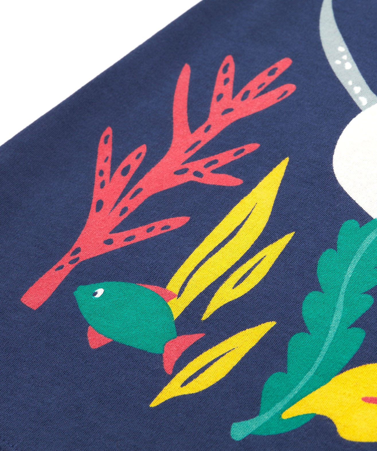 A close up of Frugi Bonnie Dress in Navy Blue, featuring a Sealife print, which includes small fish, surrounded by colourful seaweed and coral.