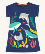 Frugi Bonnie Dress in Navy Blue laid flat, featuring a Sealife print, which includes large sea animals and smaller fish, surrounded by colourful seaweed and coral.