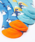 A close up of the Frugi 2 pack penguin brilliant boot socks showing the orange toe detail on organic cotton fabric