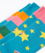 A close up of the Frugi 2 pack rainbow brilliant boot socks showing the print and cuff detail on organic cotton fabric