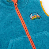 A close up of the Frugi kids bude borg fleece gilet in boat blue showing the full length zip detail on orange trim and a close up of the keep it wild patch on turquoise 100% recycled polyester material