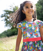 A child wearing the Frugi Bunny Bounce Issey Party Skater Dress
