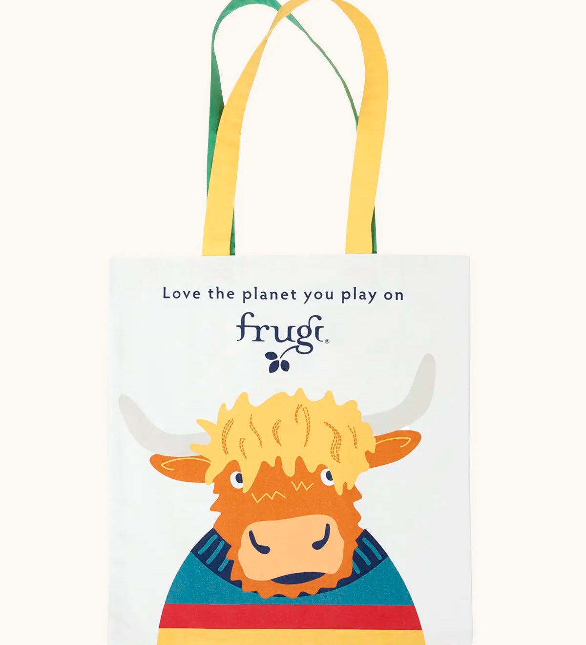 Frugi canvas tote bag in soft white with one yellow and one green strap and a highland coo cow design on the front.