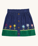 A Frugi Cara cord children's skirt in ink blue with flower and grass details. 