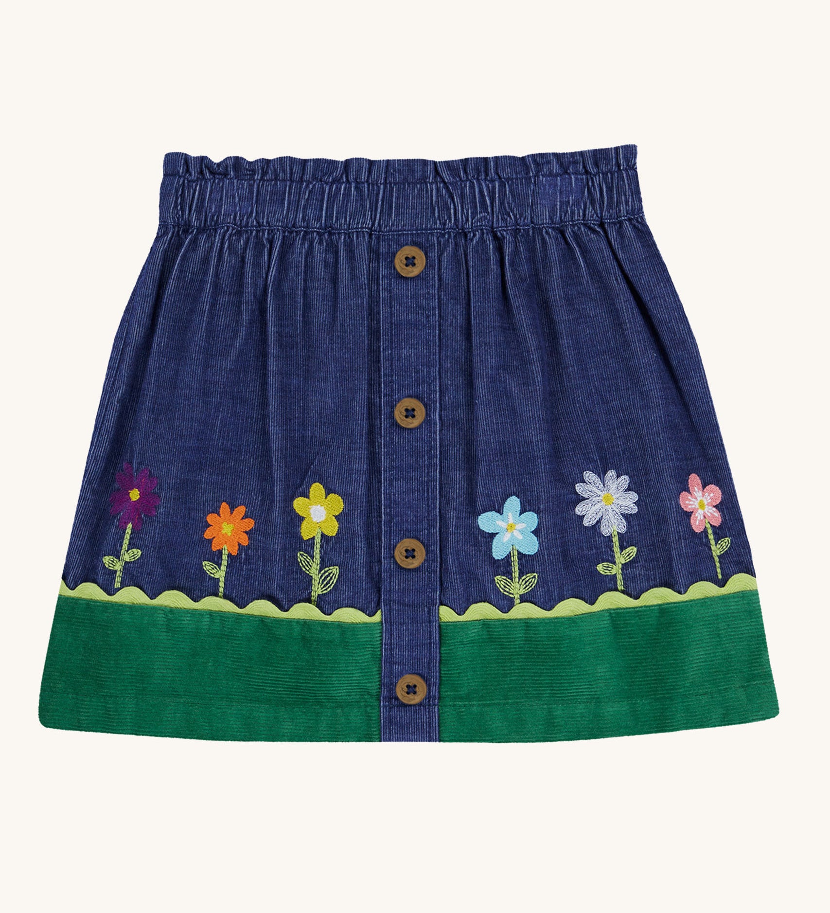 A Frugi Cara cord children's skirt in ink blue with flower and grass details. 