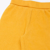 Close up of the soft cotton waistband on the Frugi carne organic cotton cord pull up trousers in bumblebee yellow.