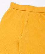 Close up of the soft cotton waistband on the Frugi carne organic cotton cord pull up trousers in bumblebee yellow.