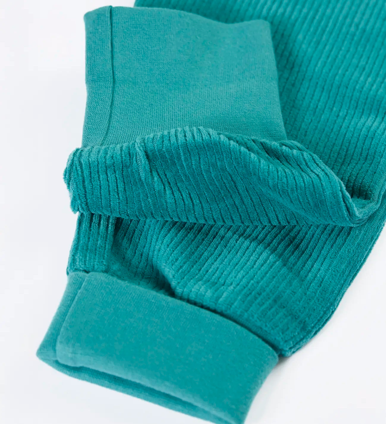 Close up of the soft cotton fold down cuffs on the Frugi carne organic cotton cord pull up trousers in hut green 