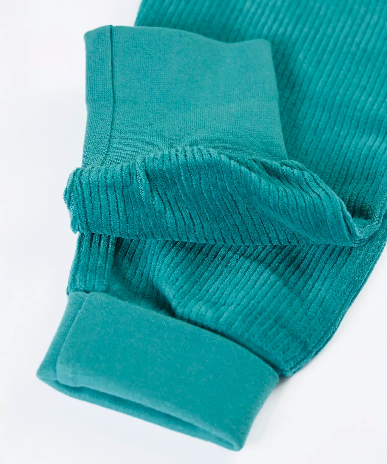 Close up of the soft cotton fold down cuffs on the Frugi carne organic cotton cord pull up trousers in hut green 