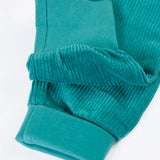 Close up of the soft cotton fold down cuffs on the Frugi carne organic cotton cord pull up trousers in hut green 