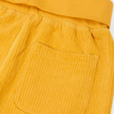 Close up of the back pocket on the Frugi carne organic cotton cord pull up trousers in bumblebee yellow with soft cotton waistband and cuffs that can be folded down for extended wear.