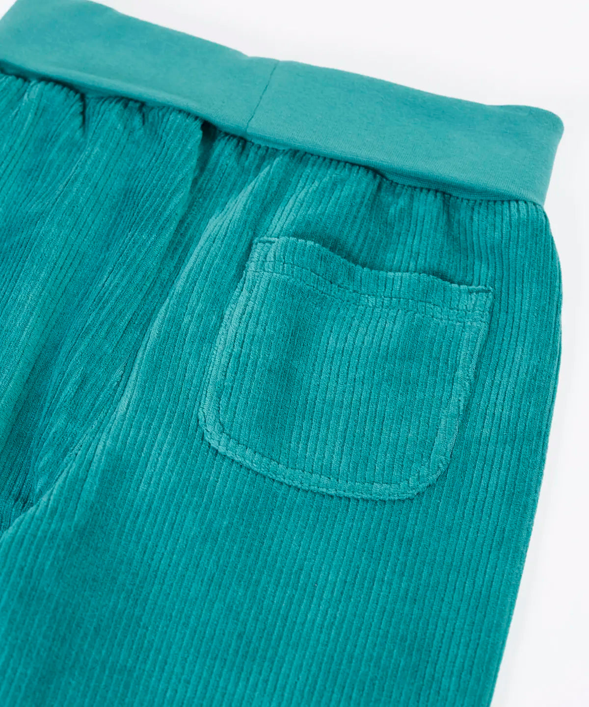 Close up of the back pocket on the  Frugi carne organic cotton cord pull up trousers in hut green.