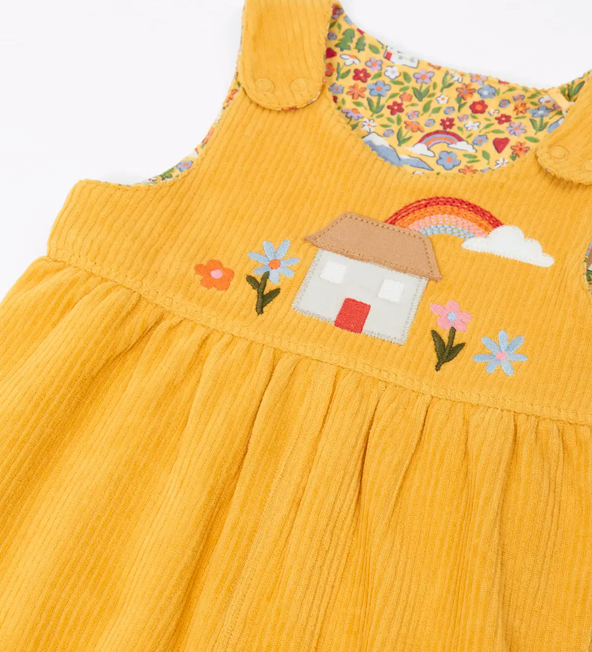 Frugi GOTS 100% organic cotton reversible dungarees in yellow corduroy with a cute highland cottage applique on the front and popper fasteners on the shoulders straps