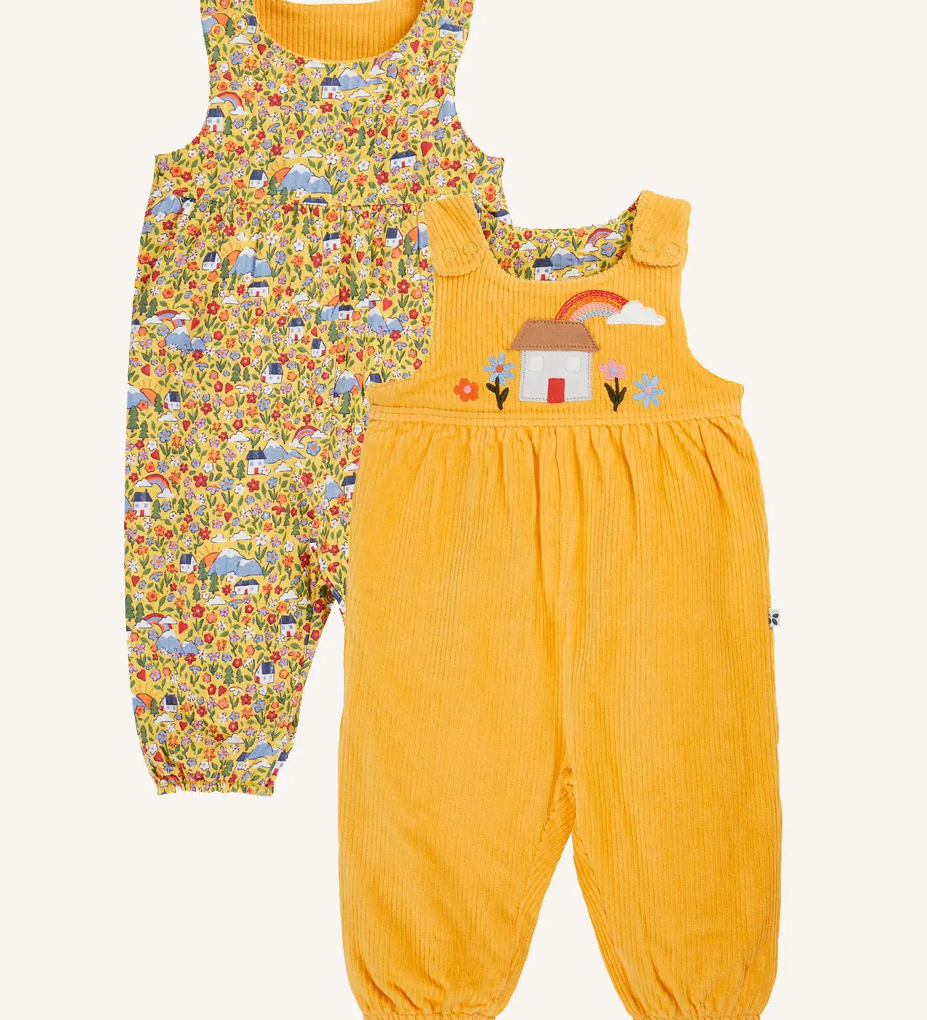 Frugi catrin reversible dungarees bumble yellow highland houses. One side is a bumble yellow corduroy with highland house applique on the front, the other side features an all over highland house print.