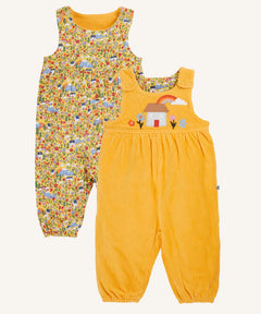 Frugi catrin reversible dungarees bumble yellow highland houses. One side is a bumble yellow corduroy with highland house applique on the front, the other side features an all over highland house print.