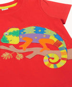 Close up of the multi coloured chamelon on a branch applique on the front of the Frugi red organic cotton short sleeved kids T-Shirt. 