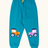 Frugi character joggers in boat blue with tractor appliques on each knee, one orange and one purple. 