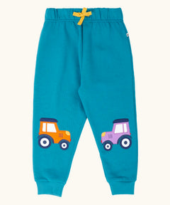 Frugi character joggers in boat blue with tractor appliques on each knee, one orange and one purple. 