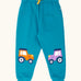 Frugi character joggers in boat blue with tractor appliques on each knee, one orange and one purple. 