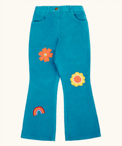 Frugi cherry boat blue corduroy flared trousers with two flowers and a rainbow badge stye details. 
