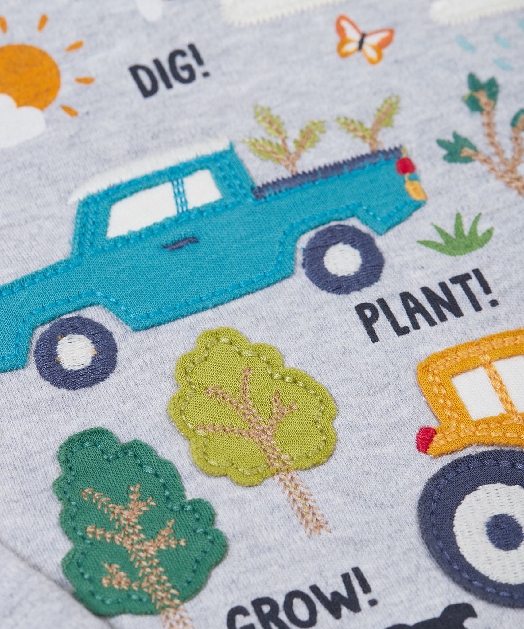A super close up of the design on the front of the Frugi children's Adventure Organic Cotton long sleeved Top in Grey with a Farm design.