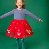 Child wearing the Frugi emmie skater dress with a long sleeved navy stripe top half and red robin applique skirt twirling around.