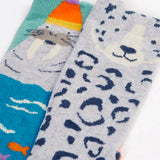 Close up of the Frugi organic cotton character socks 2 pack. One blue pair with a walrus wearing a bobble hat, one pair with a grey leopard.