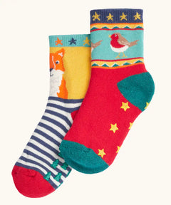 Frugi children's organic cotton grippy socks 2 pack fox fair isle. One pair has navy and white stripes with a fox on a yellow background with green grippy trees on the bottom. One pair has a robin fair isle design with yellow grippy stars on the bottom.