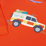 Close up of the front of the Frugi owen children's organic cotton long sleeved orange with a mountain rescue vehicle on the front. 