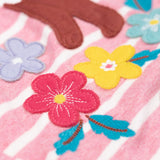 A close up of the flower appliques on the Frugi organic cotton archer pine marten applique top pink stripe.