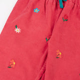 Close up Frugi children's tabitha rose pink organic cotton corduroy trousers with flower embroidery details showing the blue cotton waist tie. 